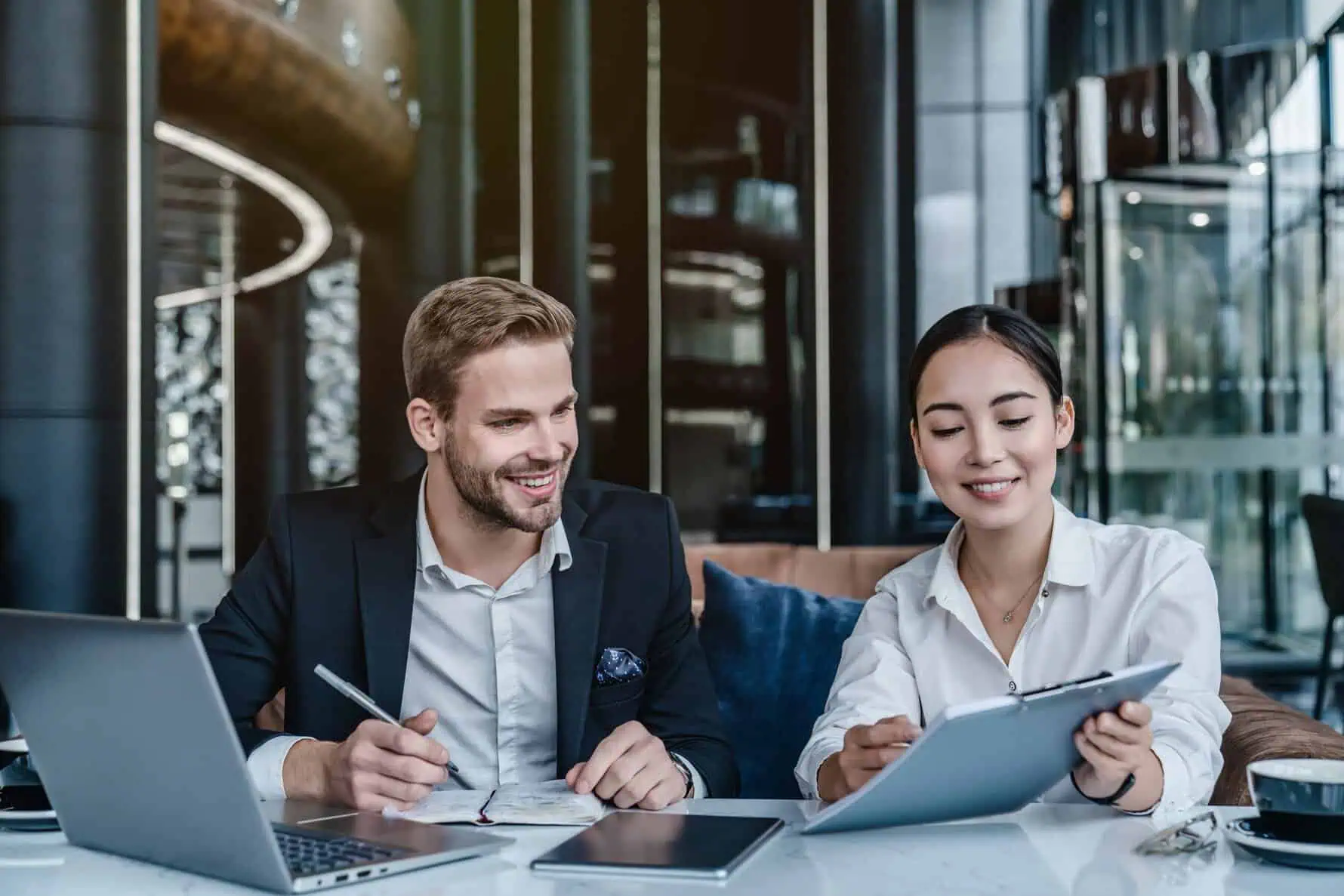 two,business,colleagues,discussing,report,document,at,work.,ceo,and